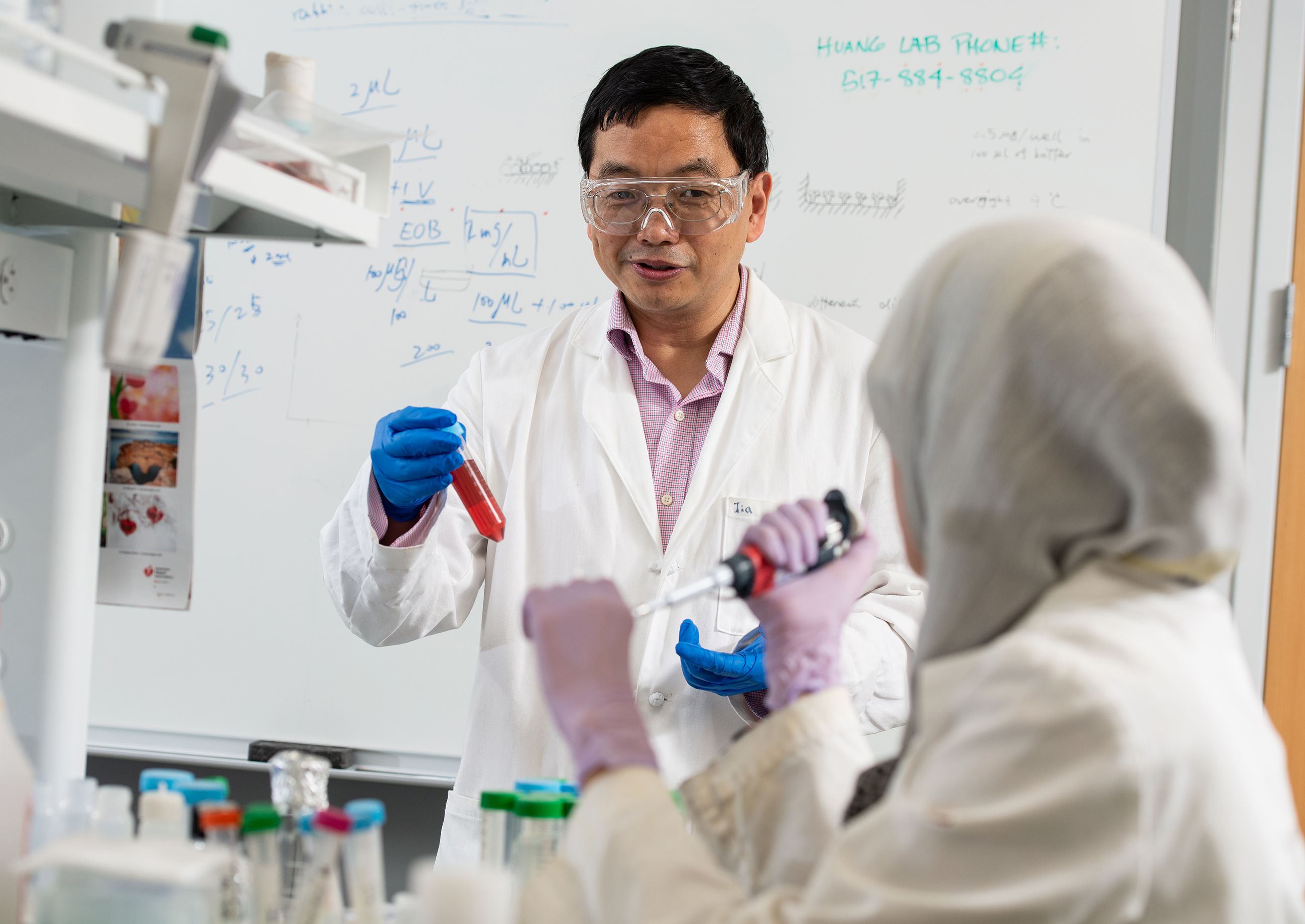 MSU chemist Xuefei Huang and then Ph.D. student Zahara Rashidijahanabad working in the Huang Group lab. Credit: Harley J. Seeley.